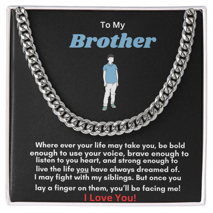 A Cuban link chain necklace with an overlay of silver or gold color, featuring an adjustable length and a parrot clasp, packaged in a black box with a textured background.
